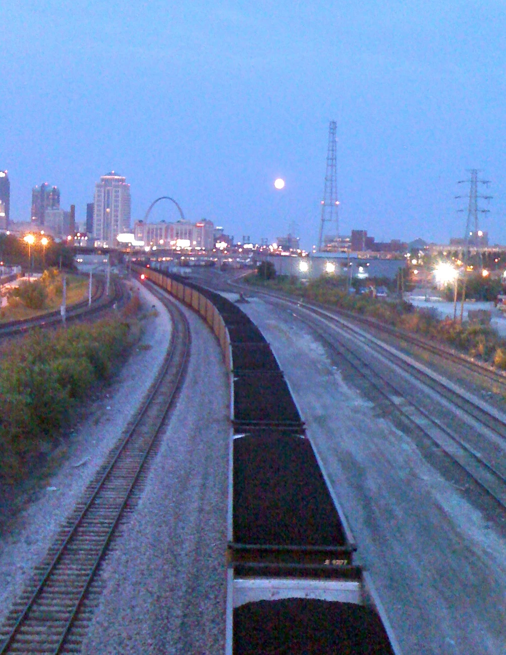 Dusk riding to the race. Full moon over the tracks. St. Louis arch in the background. 