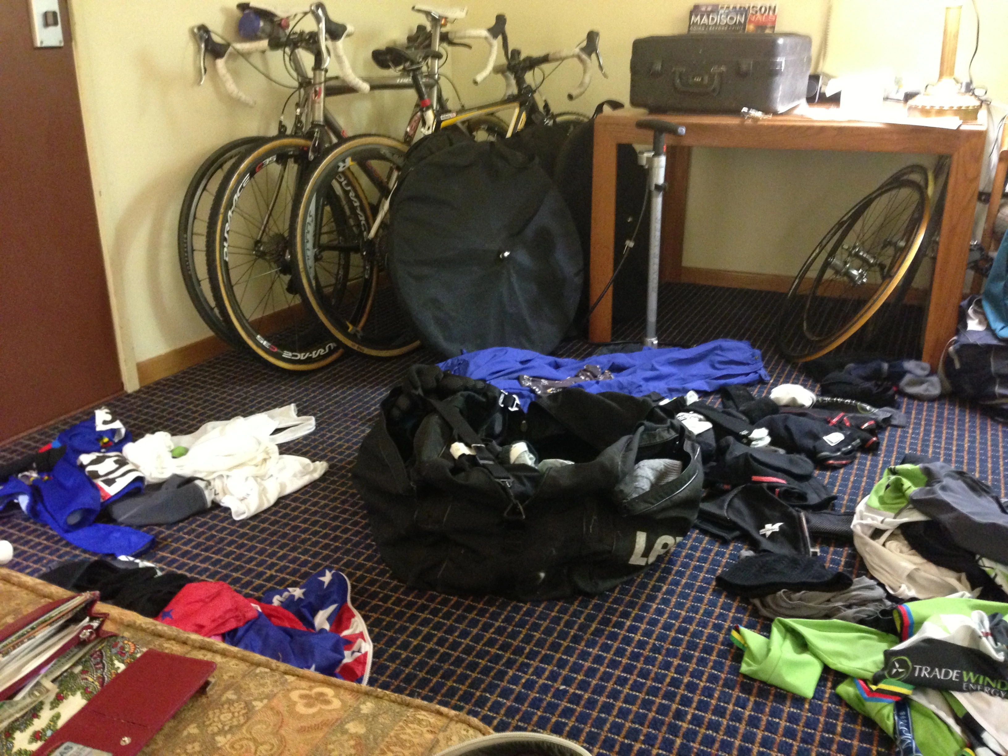 The room is a mess trying to lay out piles of clothing for each part of the day.