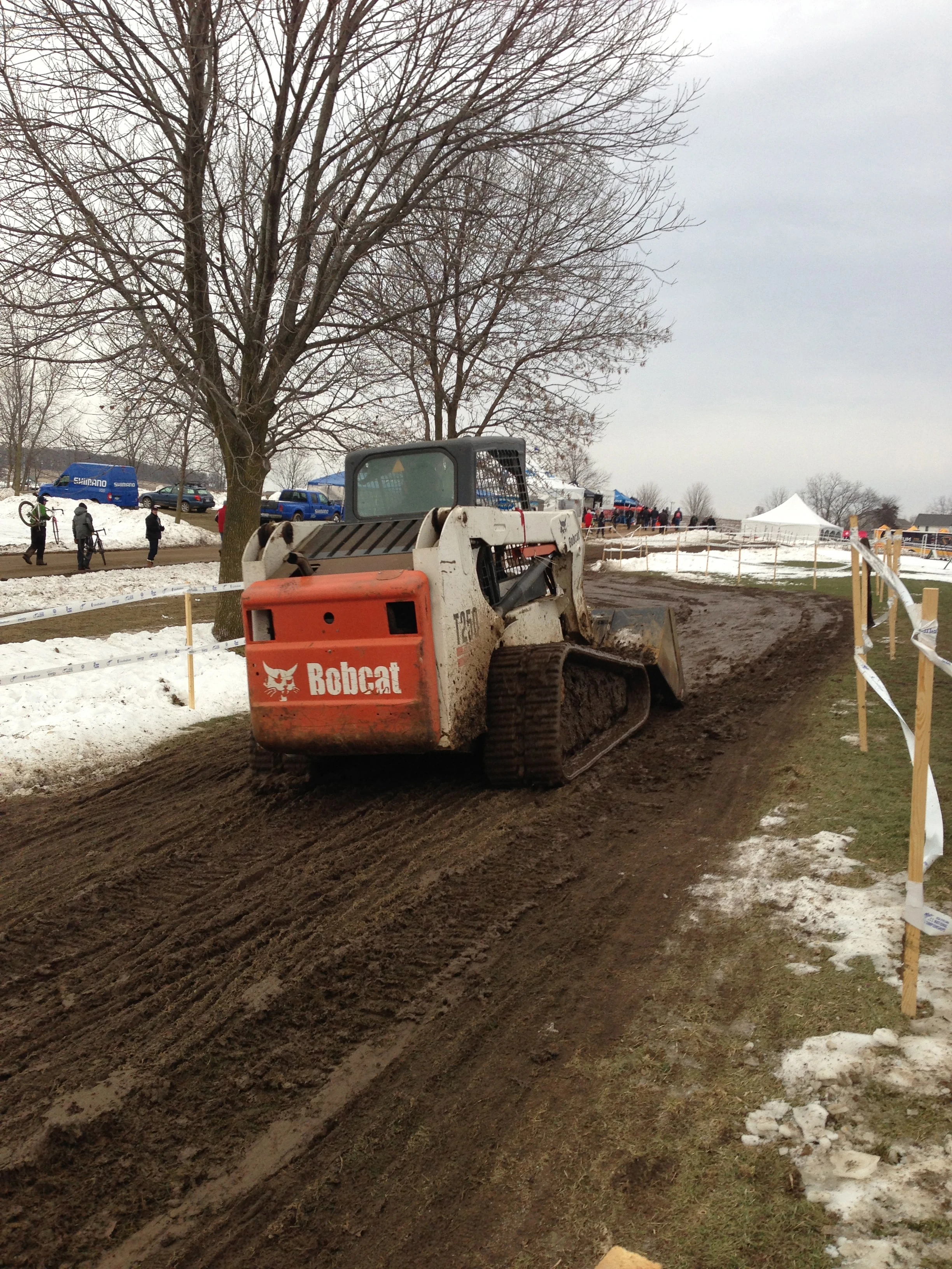 Backing the Bobcat to flatten the ruts.