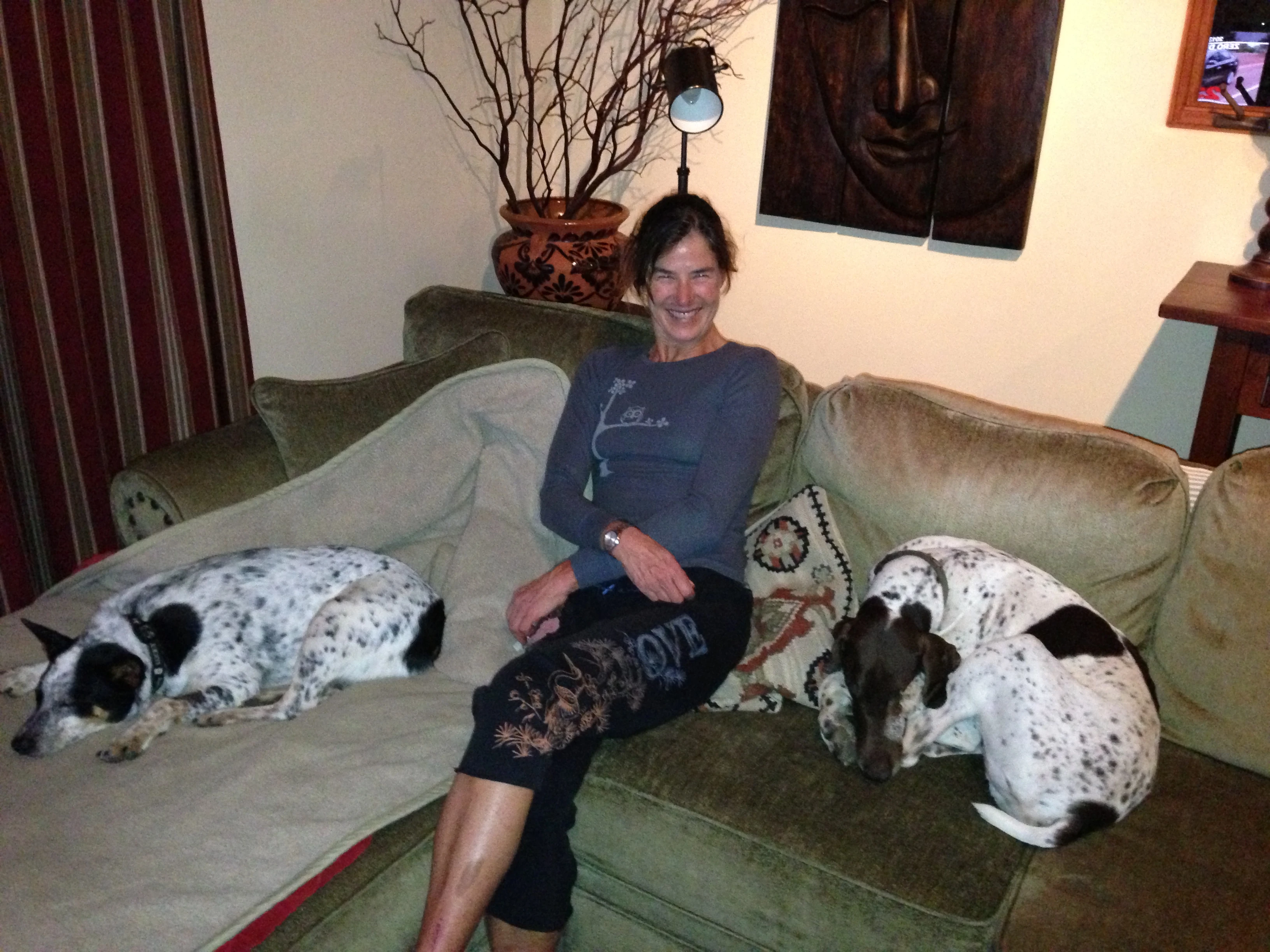 Sue sitting with her two babies, Kya and Ranger. Between the two of them, they have two eyes. They are both survivors.