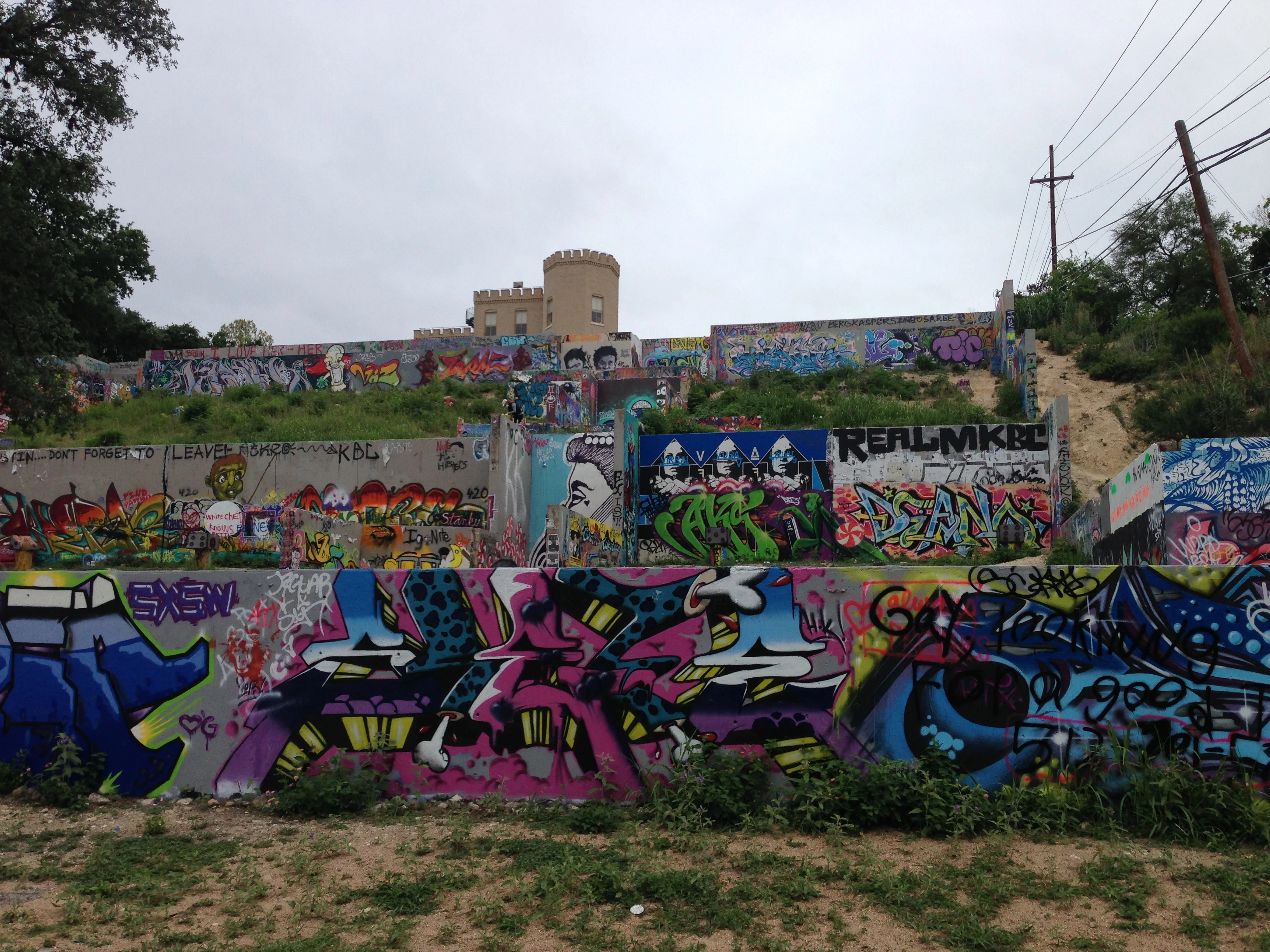 This is on the North side of the river, close to 6th street. It is kind of surprising finding it in a residential neighborhood. If you look carefully, on the third tier, you can see a woman, with a mask, spray painting.