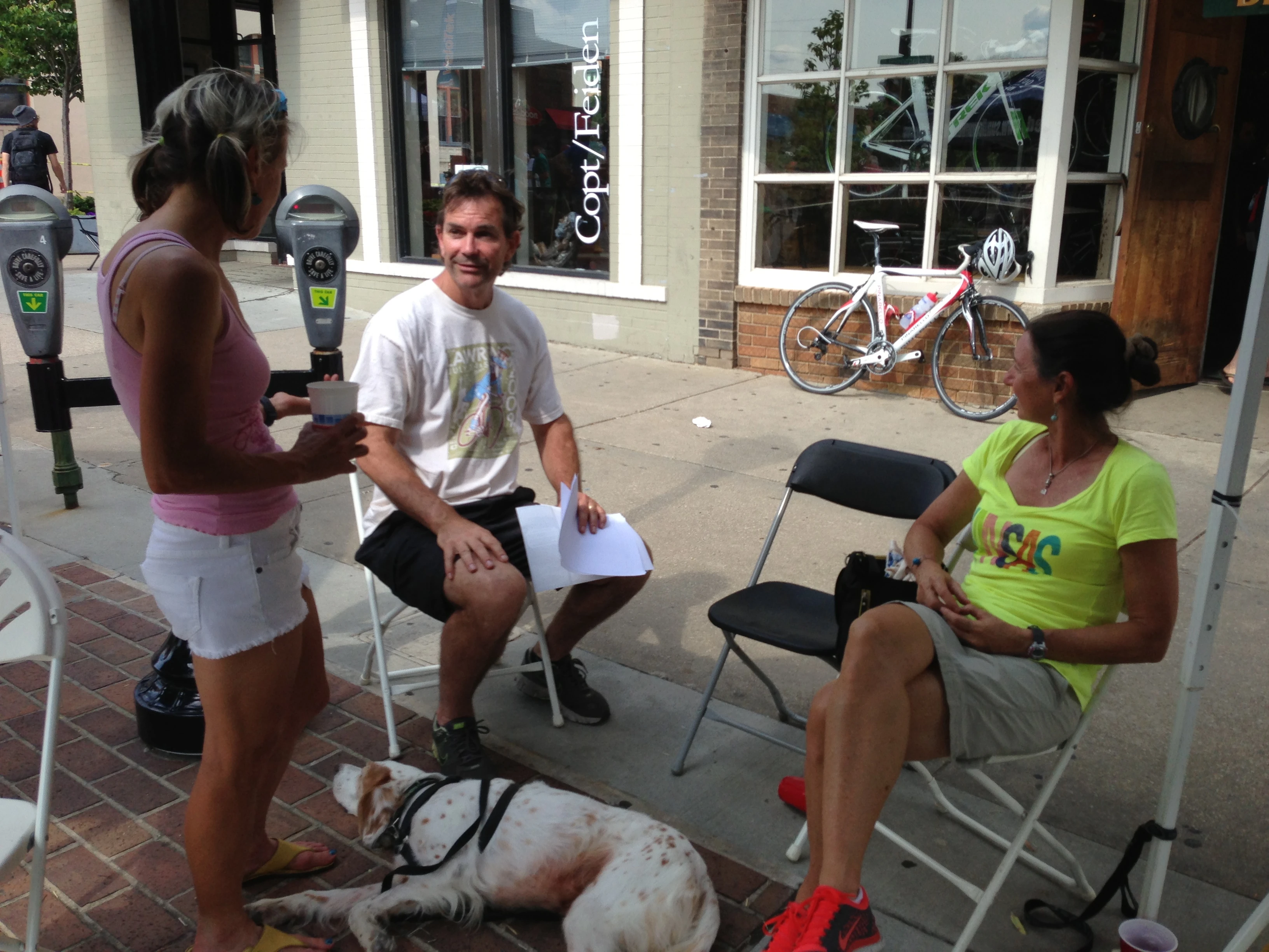 Bob Sanner, the Executive Director for the Lawrence Sports Corporation, Catherine, Bromont and Trudi hanging at the Sunflower tent.