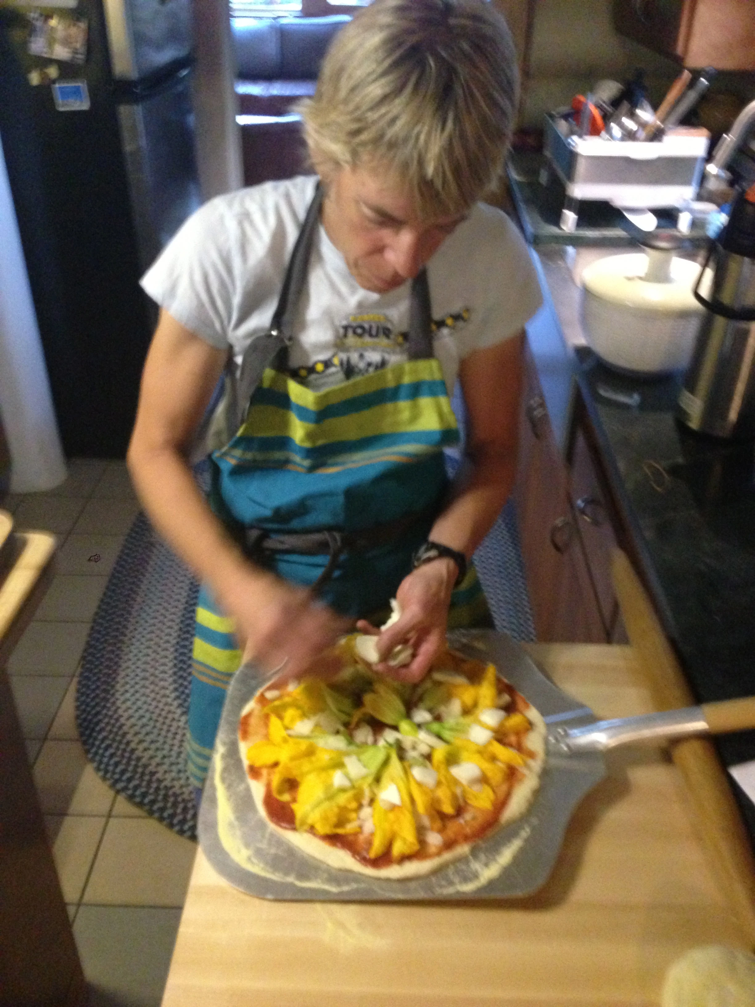 And once again, Katie creating. This is a squash blossom pizza. The only other time I have had squash blossom was in San Diego. They were fried. I very much doubt I would eat them raw. I must be a Colorado/California thing.