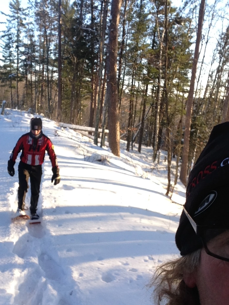 Over the shoulder shot of Bill following me snowshoeing.
