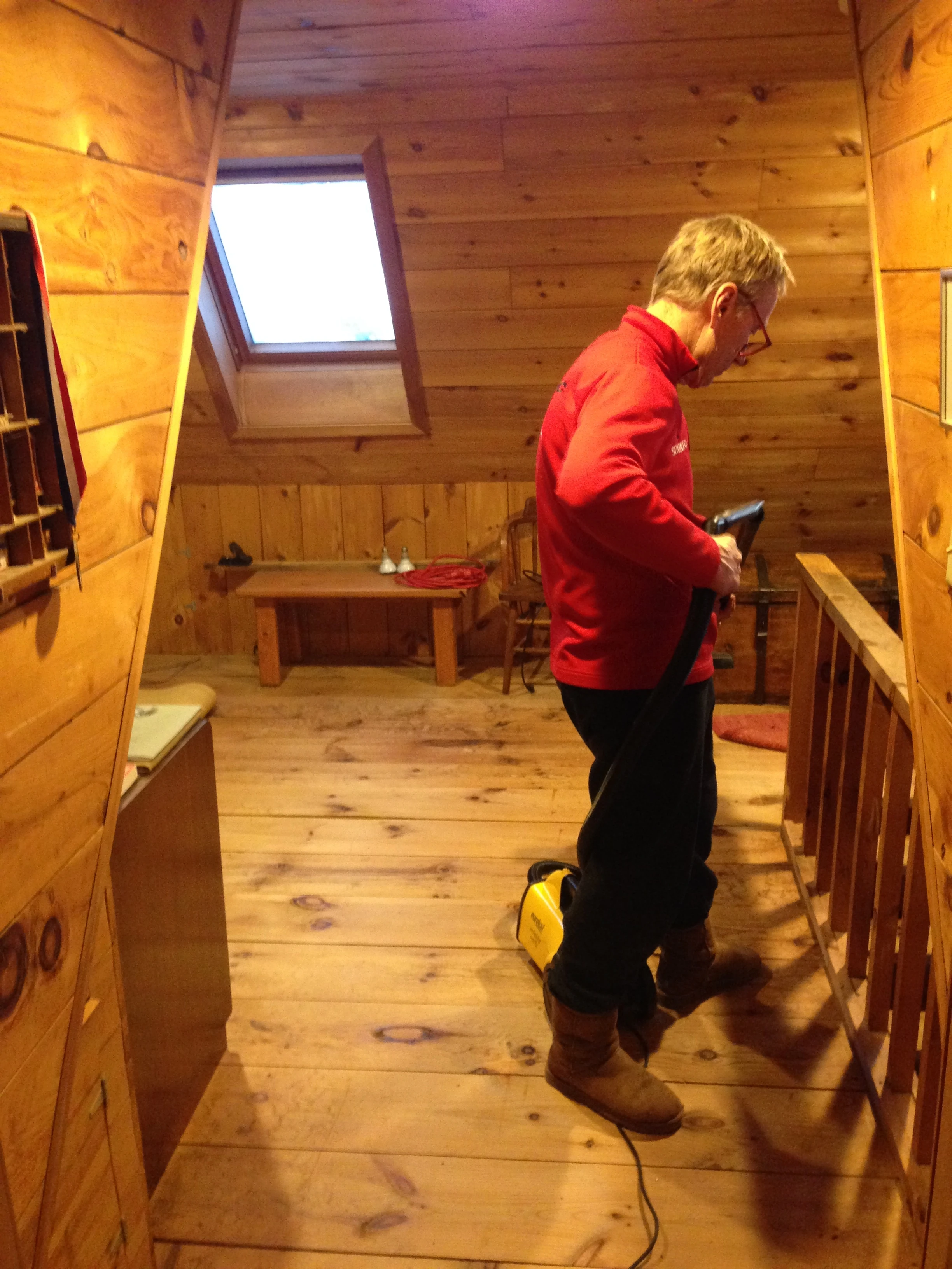 Dennis cleaning up the loft after installing new cannister lights.