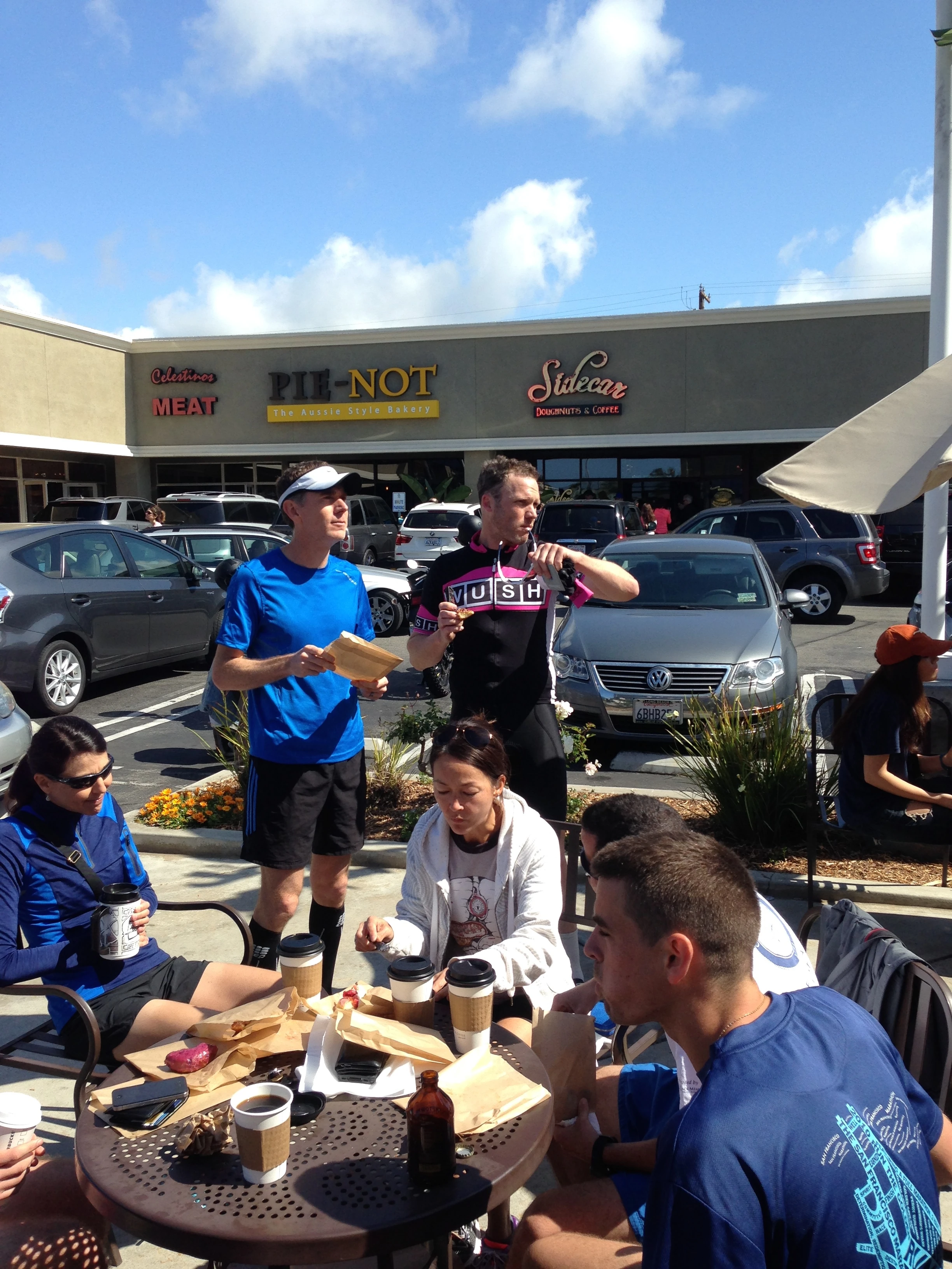 The runners eating donuts.