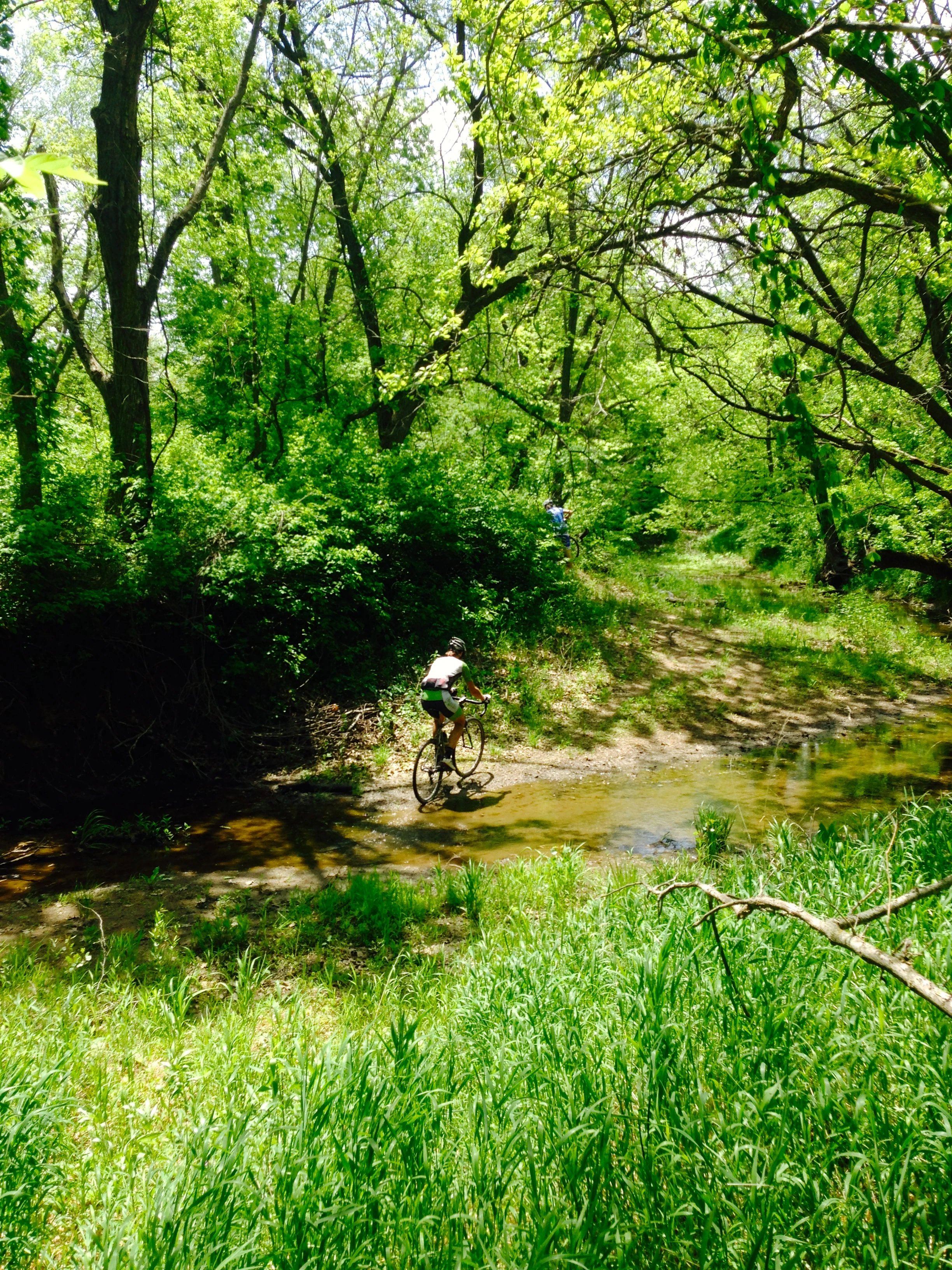 Brian riding across a small stream. I didn&rsquo;t have to dismount the whole time. I was wearing my carbon road shoes.