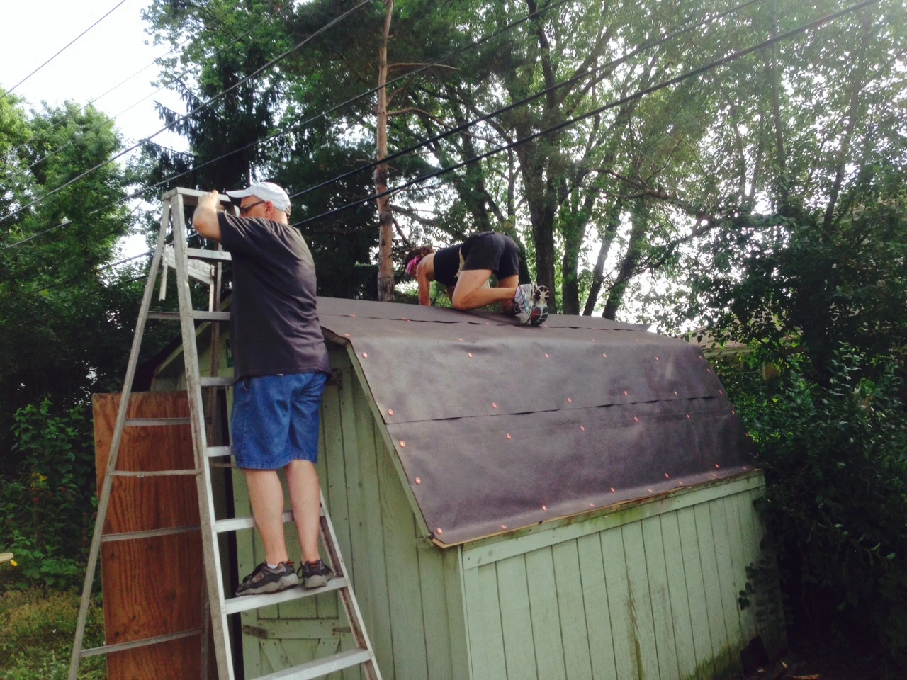 Trudi and her brother, Bob, nailing on the felt.
