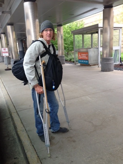 At the Madison airport. I have my walking stick toe strapped to my crutches. 