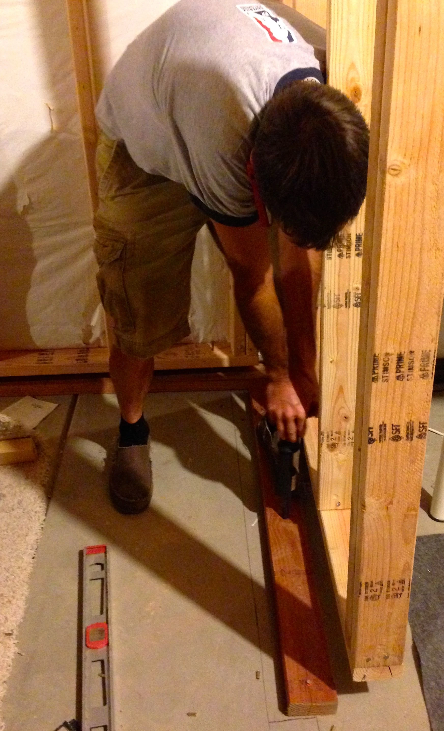 Vincent securing the plates to the concrete. The code in Colorado is that you have to hang the basement walls from the floor joists because of ground expansion. Kind of strange.
