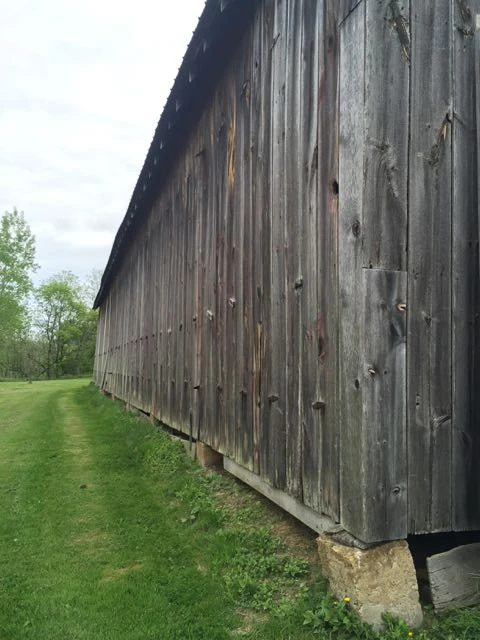 The side of the barn have hinges and it opens up to ventilate the tobacco I guess.