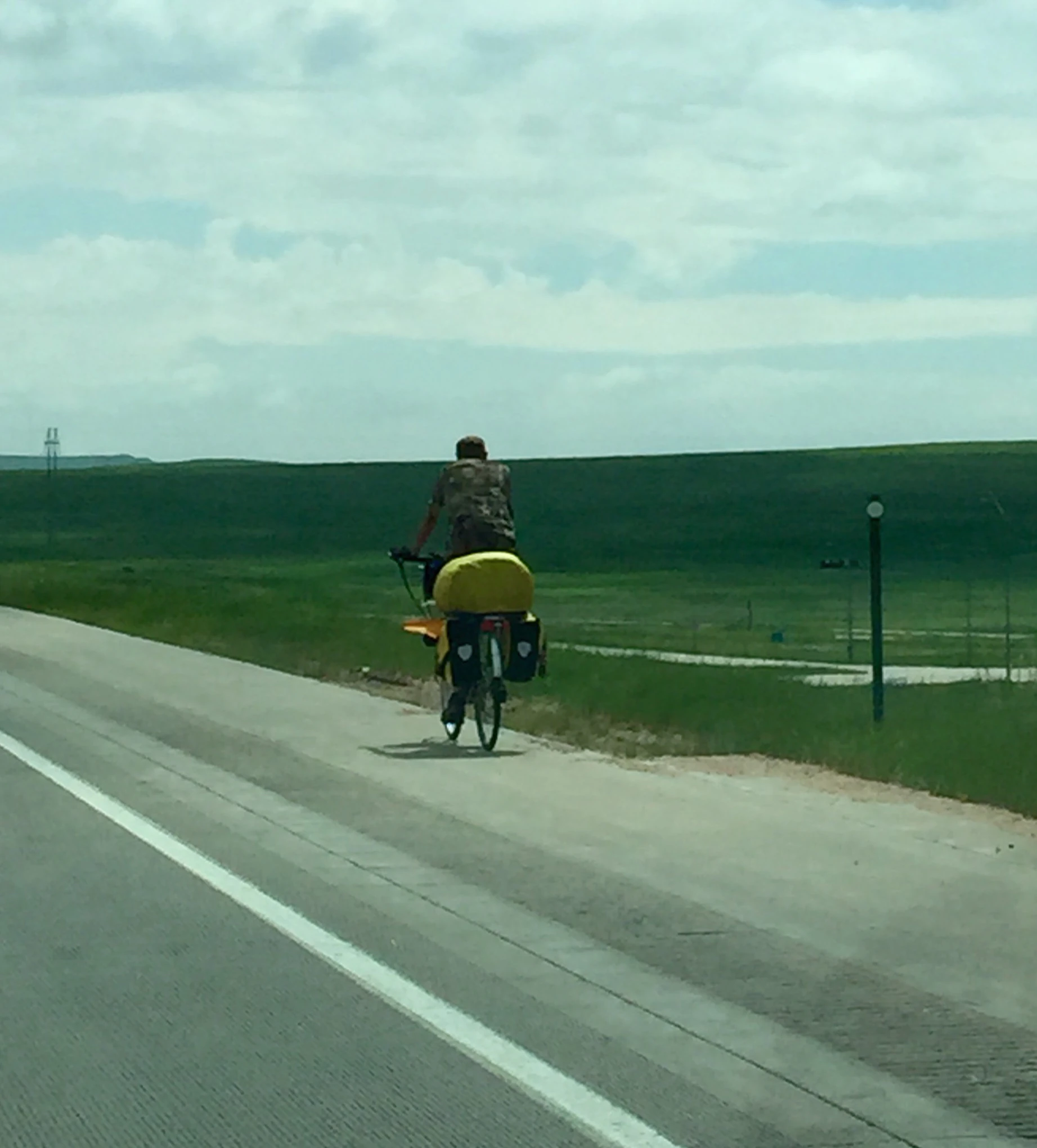 This guy was riding down I-70 outside of Limon, CO. I saw another cyclist just staying on the shoulder. Weird, not sure it is legal there to ride bikes, but I might be wrong.