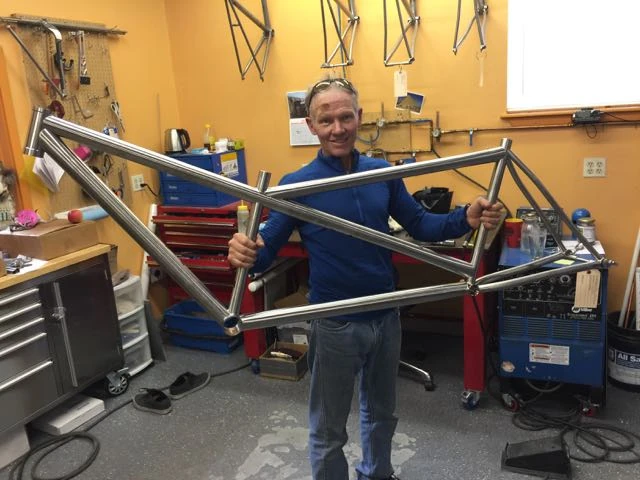 Kent holding the tacked tandem frame.