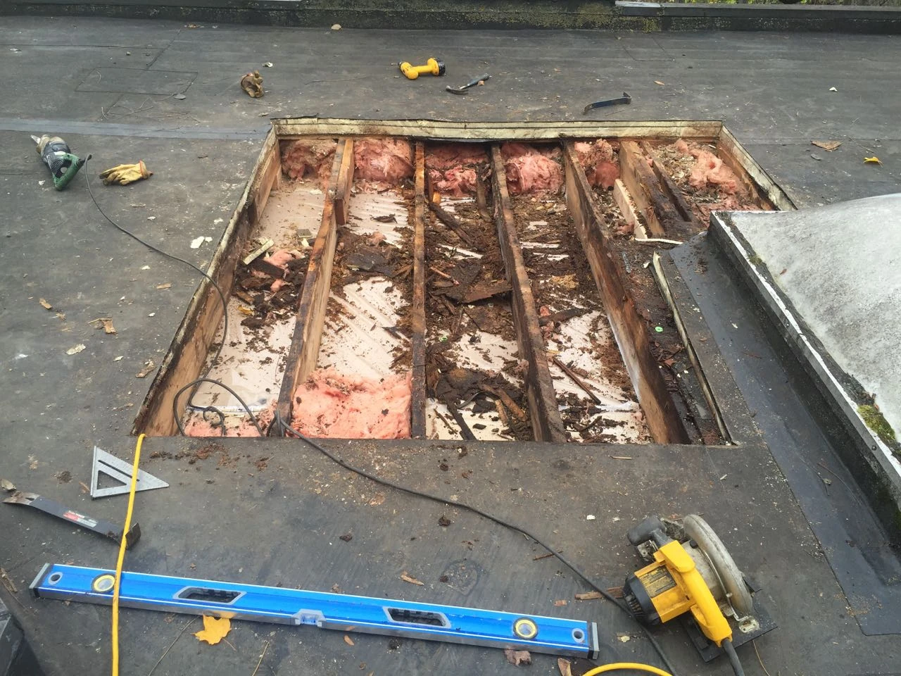 There was pretty much no sheathing. There was one rubber roof on top of another, with fiberboard below the original.