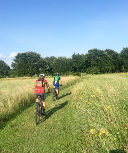 Bill and Eric riding through the open fields at the Governor&rsquo;s Mansion. Most of the ride is on great singletrack, on the river bluff.