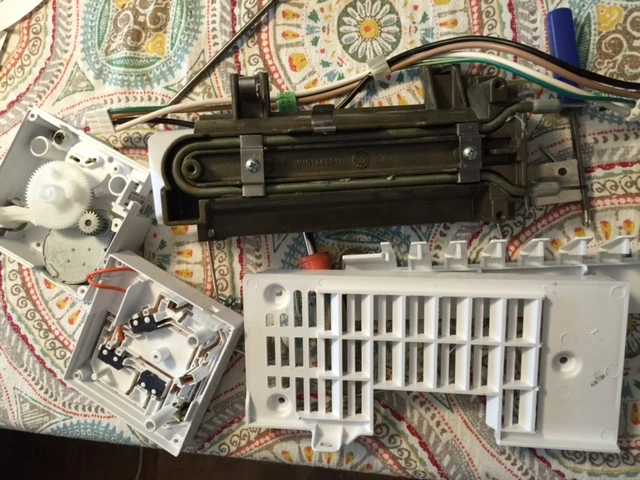 Ice maker disassembled on my kitchen table.