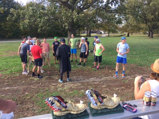 Pre-race talk. Golden running shoes as 1st place awards.