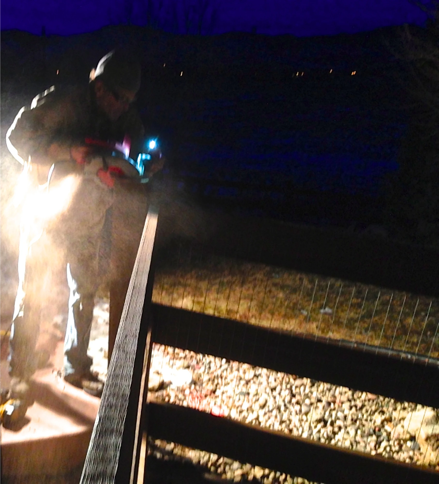 We ended up working pretty late into the night. Here is a picture Vincent took of me using the light on my iPhone to see the line on a post to miter cut it with a circular saw. Not the safest work enviornment.