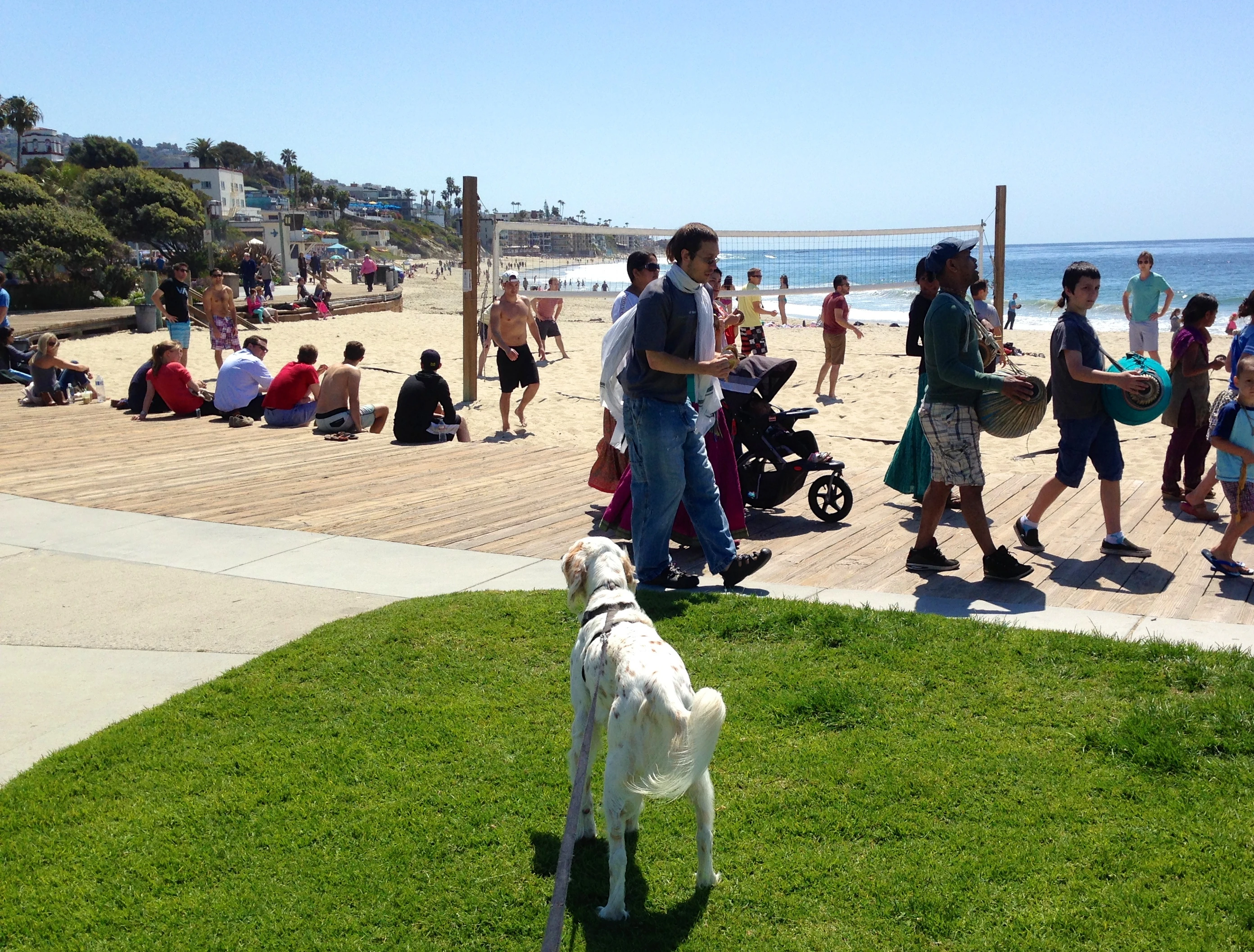Bromont watching the beach volleyball guys, while the Hare Krishna singers stroll by.
