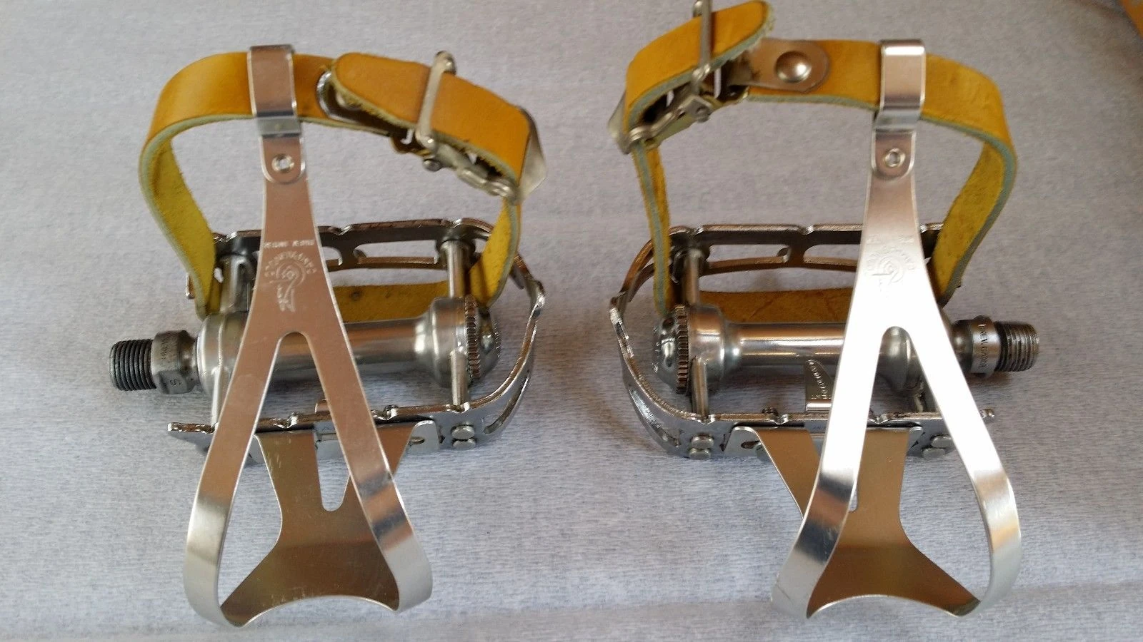 Toe clips and straps worked pretty well back in the day. I snagged this picture off eBay. I wonder if the guy selling these knows he put the straps on in reverse.