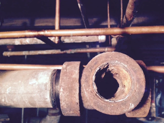 This pipe first broke off, then it took a ton of torching and quenching to finally break it free. It was probably older than me.